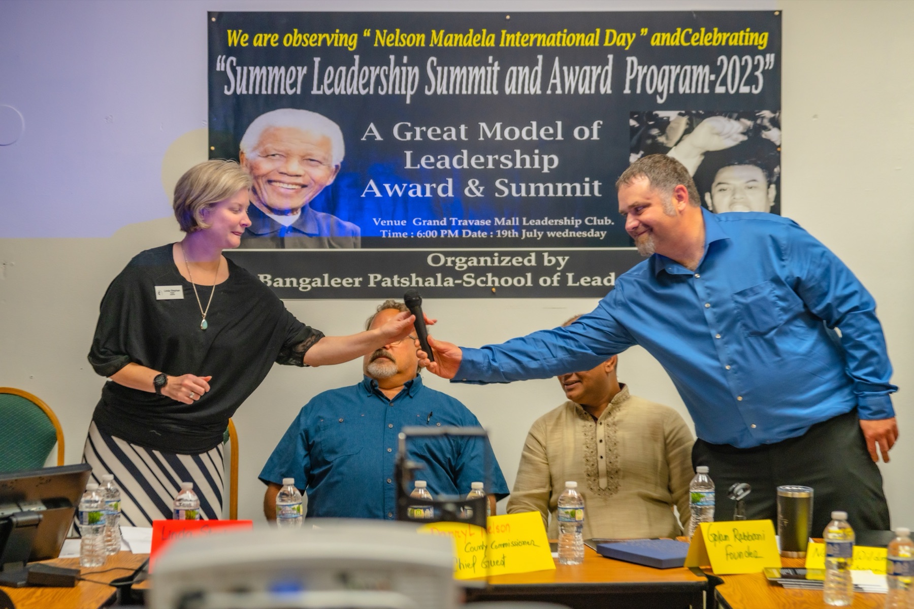 Nathan handing a microphone to a participant